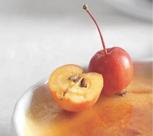A whole red apple with a stem is next to a partially visible sliced apple showing its core. Description generated by AI