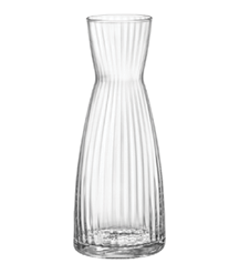A clear glass carafe with vertical ridges and a narrow neck. Description generated by AI