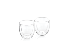 Two clear double-walled glass cups are placed side by side on a white reflective surface. Description generated by AI