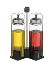 Two glass bottles with metal pour spouts containing yellow and red liquids are held in a black plastic stand with a central handle. Description generated by AI