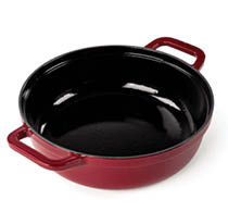 A round red cast iron pot with two handles and a glossy black interior. Description generated by AI