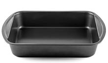 A black rectangular baking pan with slightly rounded handles on each side is shown against a white background. Description generated by AI