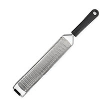 A long stainless steel grater with a black handle and a hole for hanging. Description generated by AI