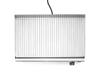 A rectangular metal grill pan with parallel raised ridges and a handle attached by a cord. Description generated by AI