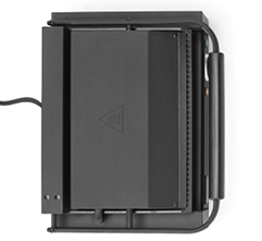 A black electronic device with a cord attached, featuring a flat surface and a triangular warning symbol on top. Description generated by AI