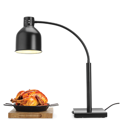 A black desk lamp with a curved neck shines light onto a roasted whole chicken in a pan resting on a wooden cutting board. Description generated by AI