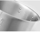 Close-up view of a metal pot with rivets visible on the inner surface and a handle attached on the side. Description generated by AI